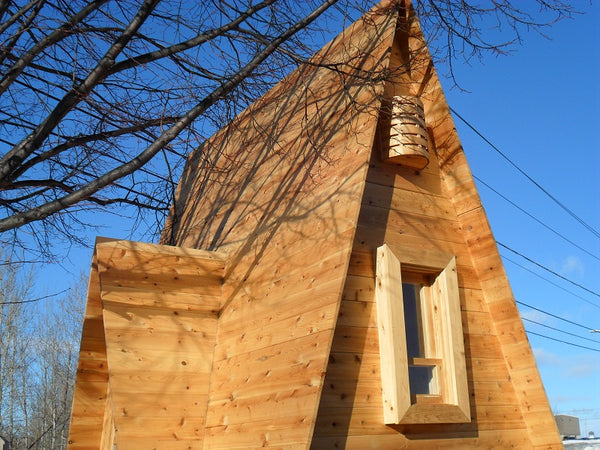 A-frame cedar sauna with custom windows and doors in Sudbury.